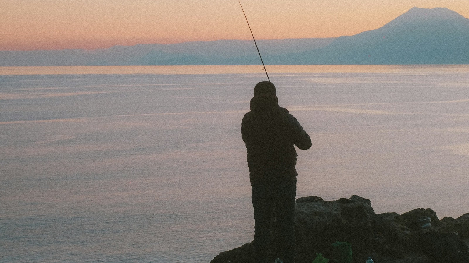 Angler casting at sunset